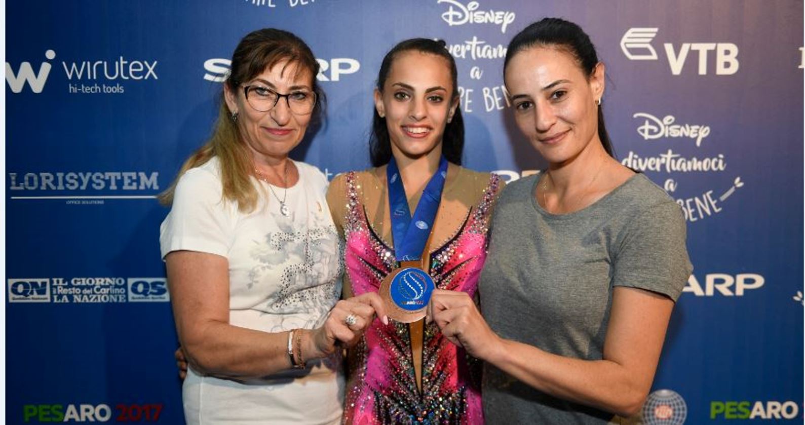 Linoy Ashram flanked by her coaches after winning a bronze medal in the 2017 World Rhythmic Gymnastics Championships in Italy, September 1, 2017. Photo by Amit Shisel