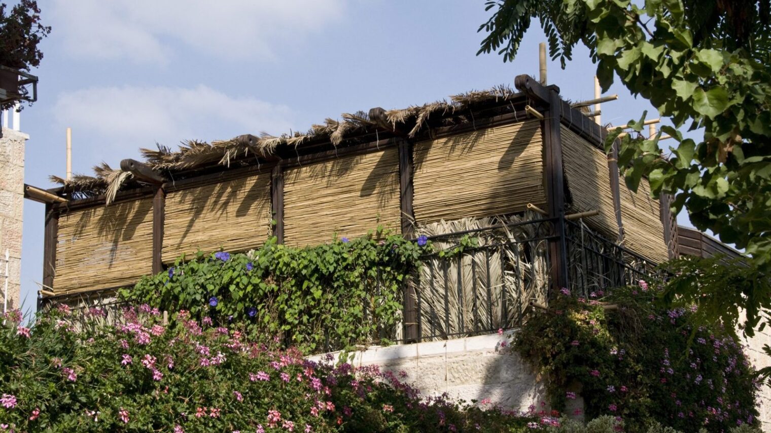 A sukkah on the roof of a home in Jerusalem’s Yemin Moshe neighborhood. Photo by Yehoshua Halevi