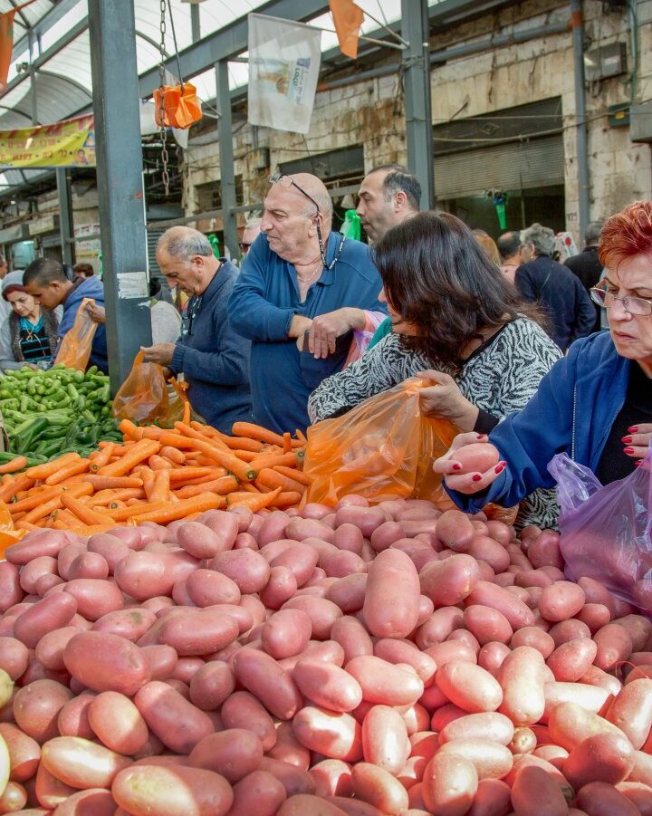 Choosing veggies in the Ramla Shuk. Photo by Moshe Shai/FLASH90