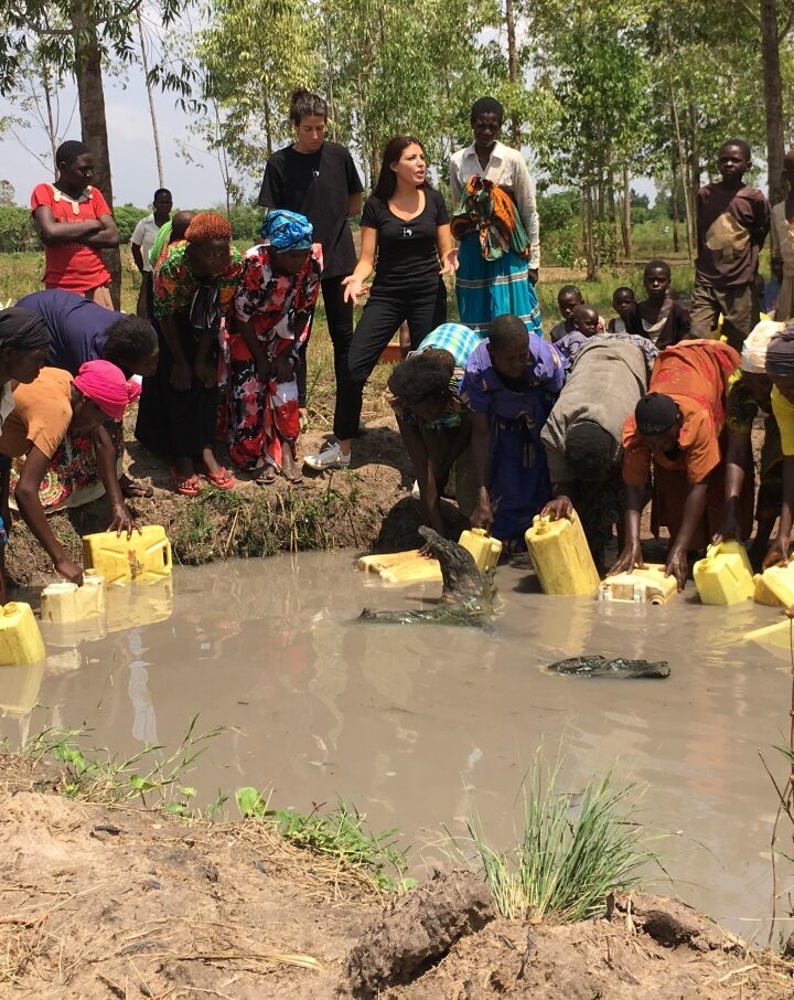 Sivan Ya’ari with Bukadukha villagers in Uganda collecting dirty water from their old water source. Photo courtesy of Innovation: Africa