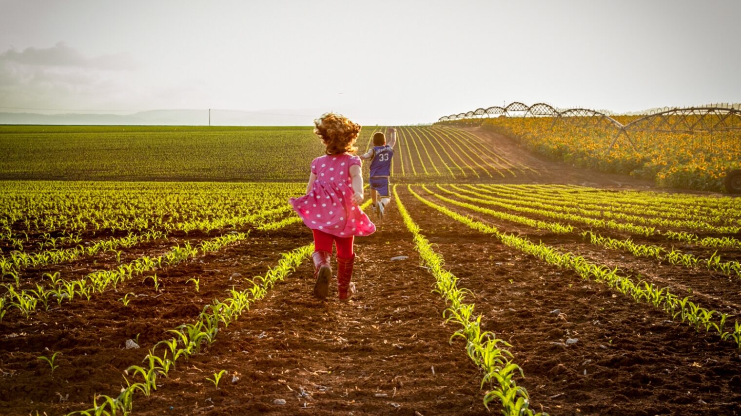 Children running through farm fields in Israel’s Jezreel Valley. Photo by Anat Hermony/FLASH90