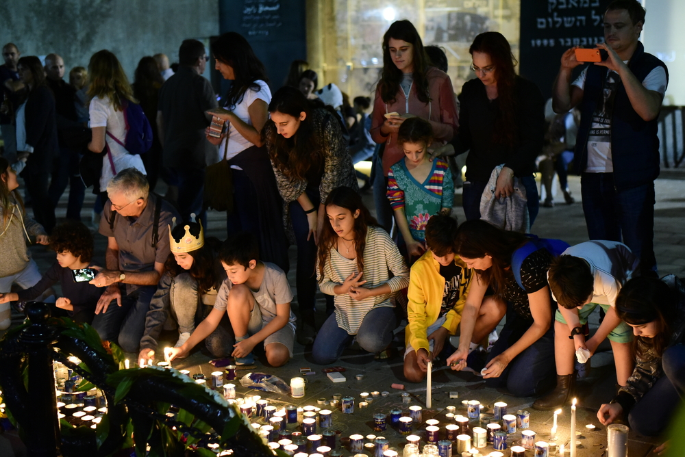 Israelis light candles in the wake of Rabin's murder. Photo via Shutterstock