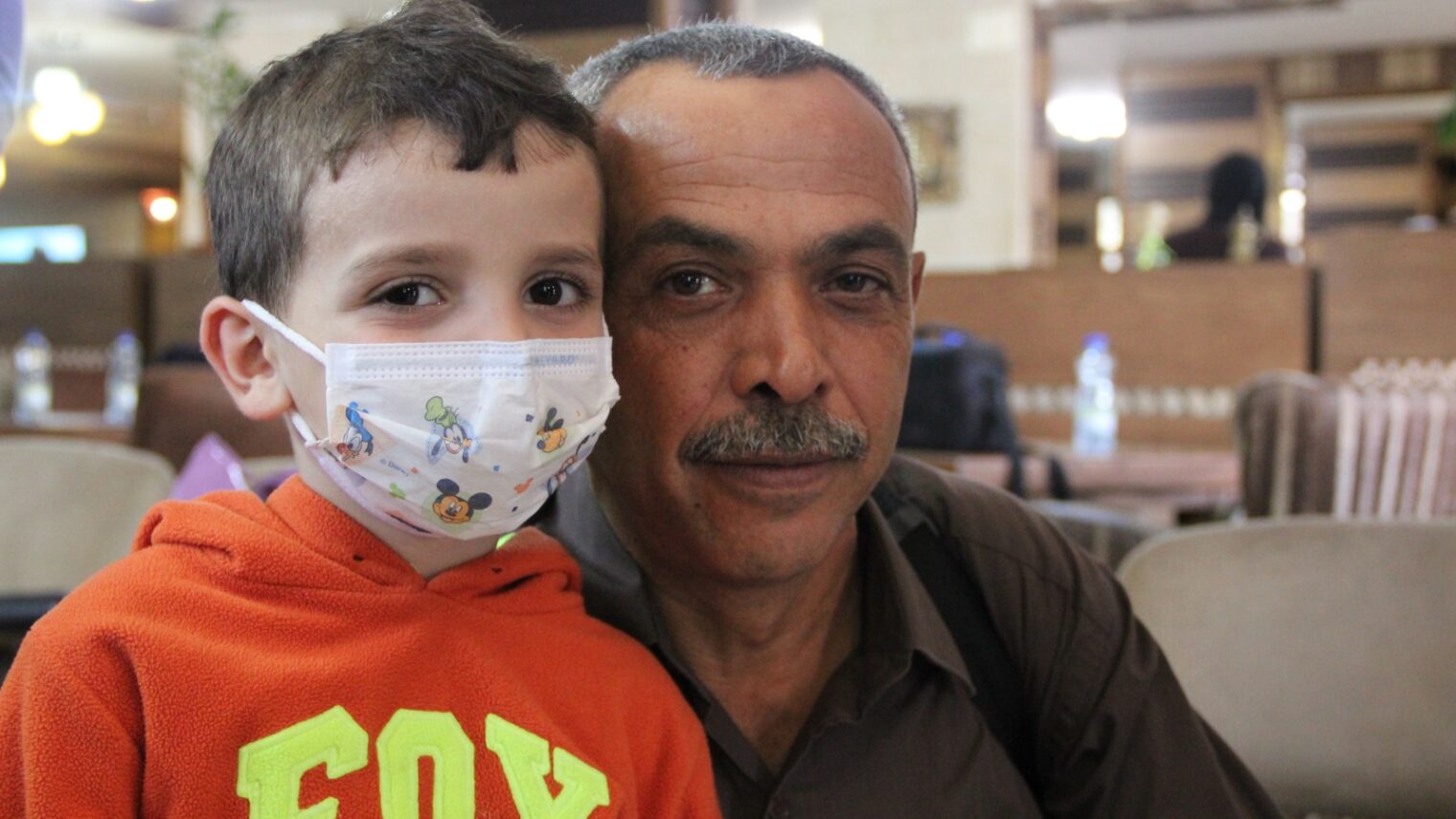 Naeem al-Bayda, West Bank coordinator of transportation for Project Rozana, with a youngster he brought to an Israeli hospital. Photo: courtesy