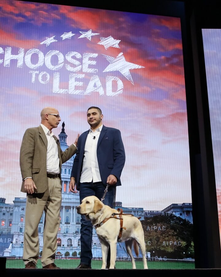 Arab-Israeli citizen Saleem Sharif with his guide dog, Winston, onstage at the 2018 AIPAC Policy Conference along with Noach Braun from the Israel Guide Dog Center. Photo: courtesy