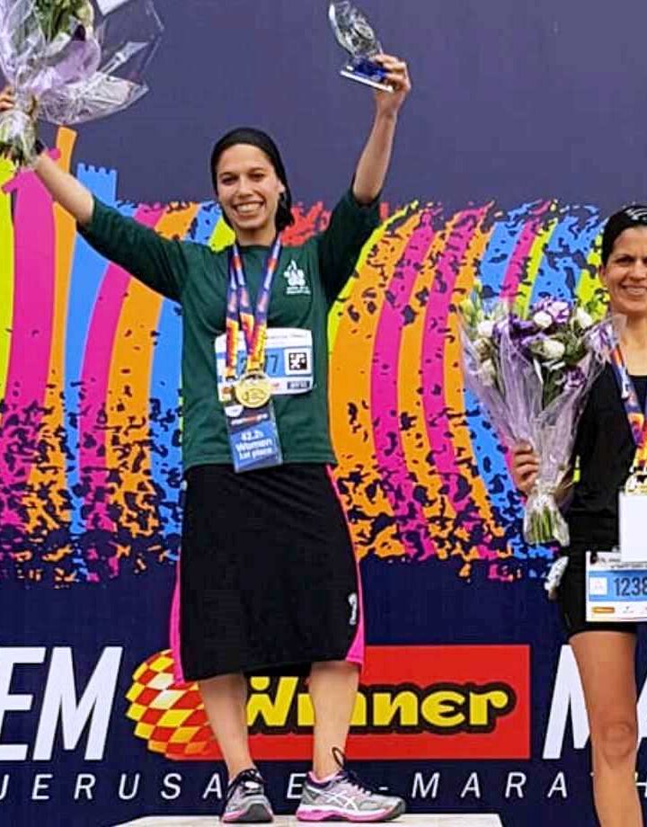 Beatie Deutsch standing on the podium after the 2018 Jerusalem Winner Marathon. Photo via Facebook