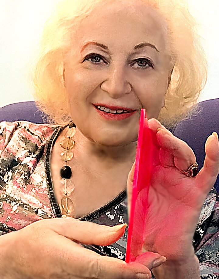 Prof. Renata Reisfeld at home with a sample of her luminescent solar concentrator. Photo by Viktoria Levchenko