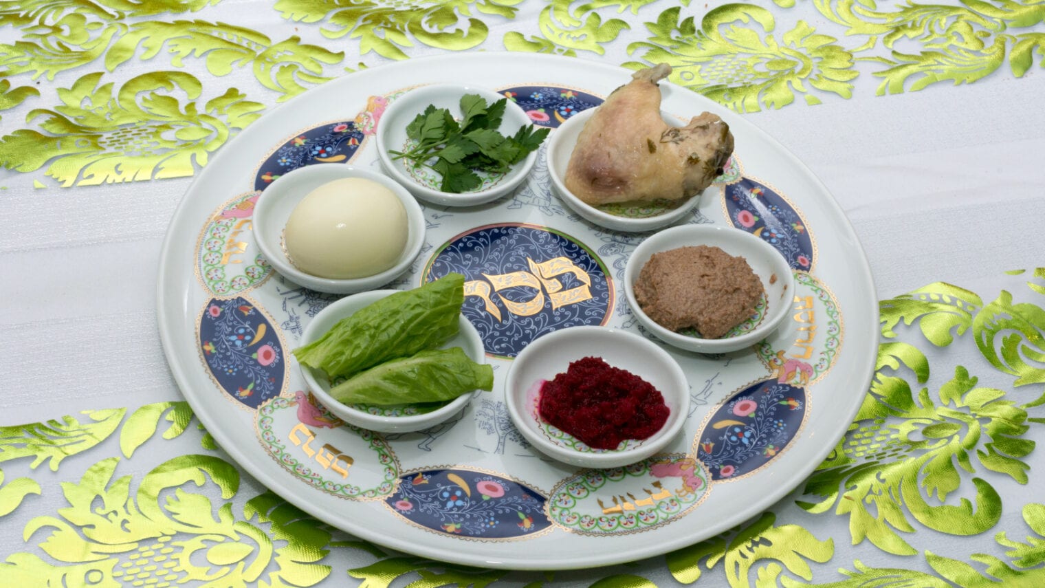 Traditional Passover Seder plate with six items that have significance to the retelling of the story of Passover, the focus of this ritual meal. Photo by D. Naveh via Shutterstock.com