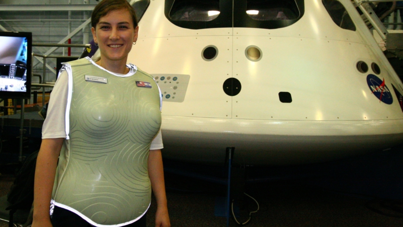 Dana Vaisler of StemRad wearing an AstroRad vest prototype in front of the Orion Capsule at Johnson Space Center in Houston. Photo: courtesy