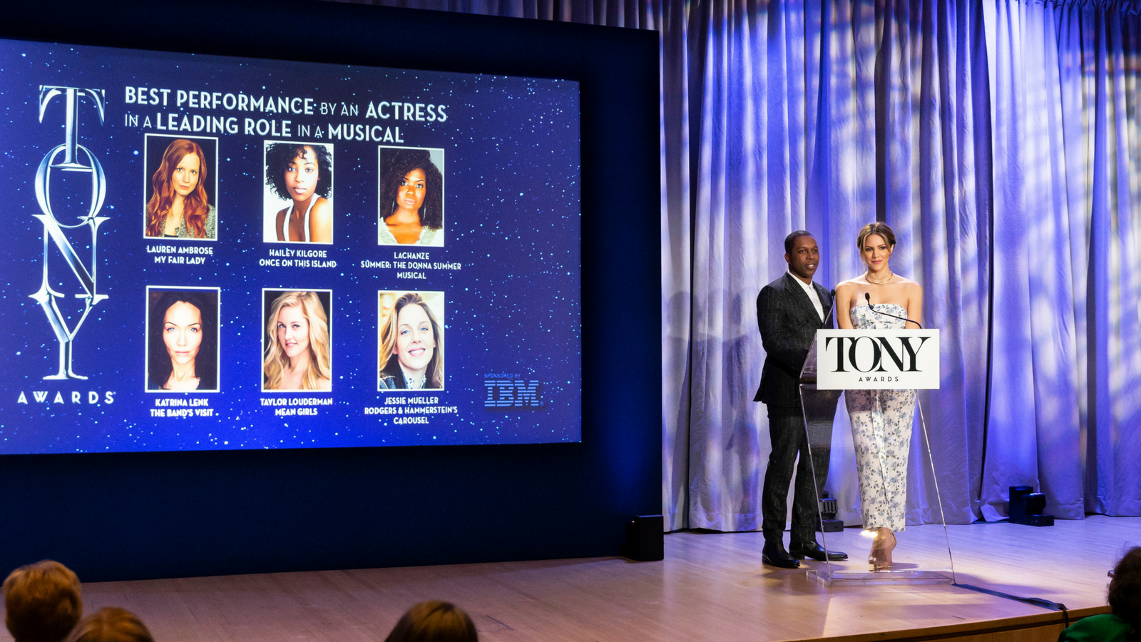 Broadway stars Leslie Odom Jr. and Katharine McPhee speak onstage during 2018 Tony Awards nominations announcement in May. Photo via Shutterstock.com