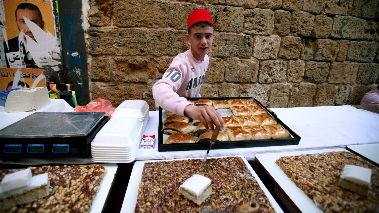 A young man selling sweets at the Old City of Acre. Photo by Moshe Shai/FLASH90