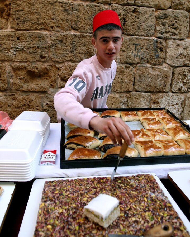 A young man selling sweets at the Old City of Acre. Photo by Moshe Shai/FLASH90