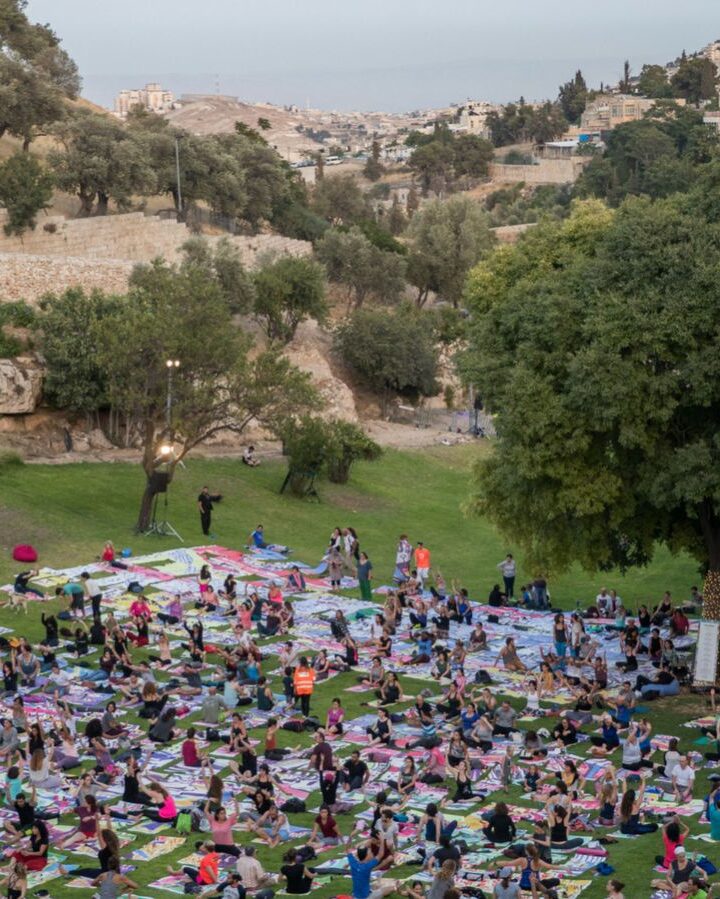 Participants attend a mass yoga class in Jerusalem, on International Yoga Day, using specially designed yoga mats that collectively form an artwork envisioning the future of Jerusalem. Photo by Yonatan Sindel/FLASH90