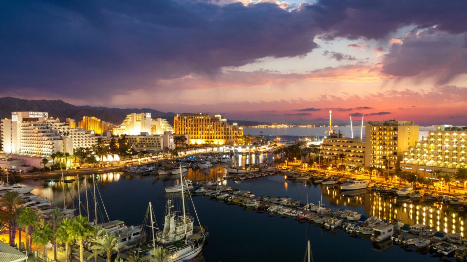 Evening view of ships anchoring at Eilat marina in front of the Red Sea. Photo via shutterstock.com