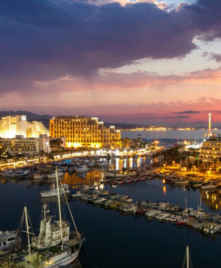 Evening view of ships anchoring at Eilat marina in front of the Red Sea. Photo via shutterstock.com