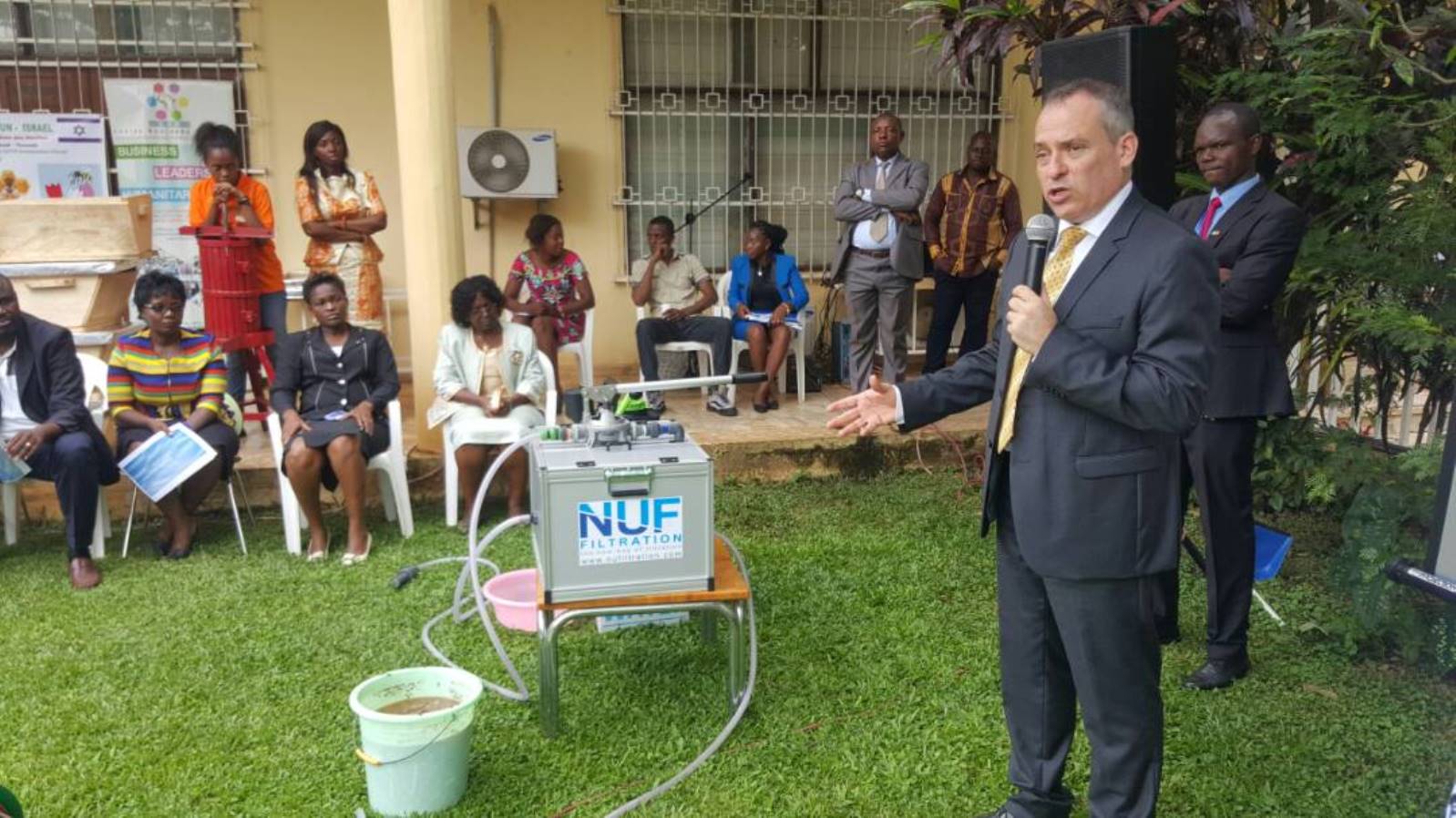 Israeli Ambassador to Cameroon Ran Gidor demonstrating a NUFiltration water purification unit. Photo: courtesy