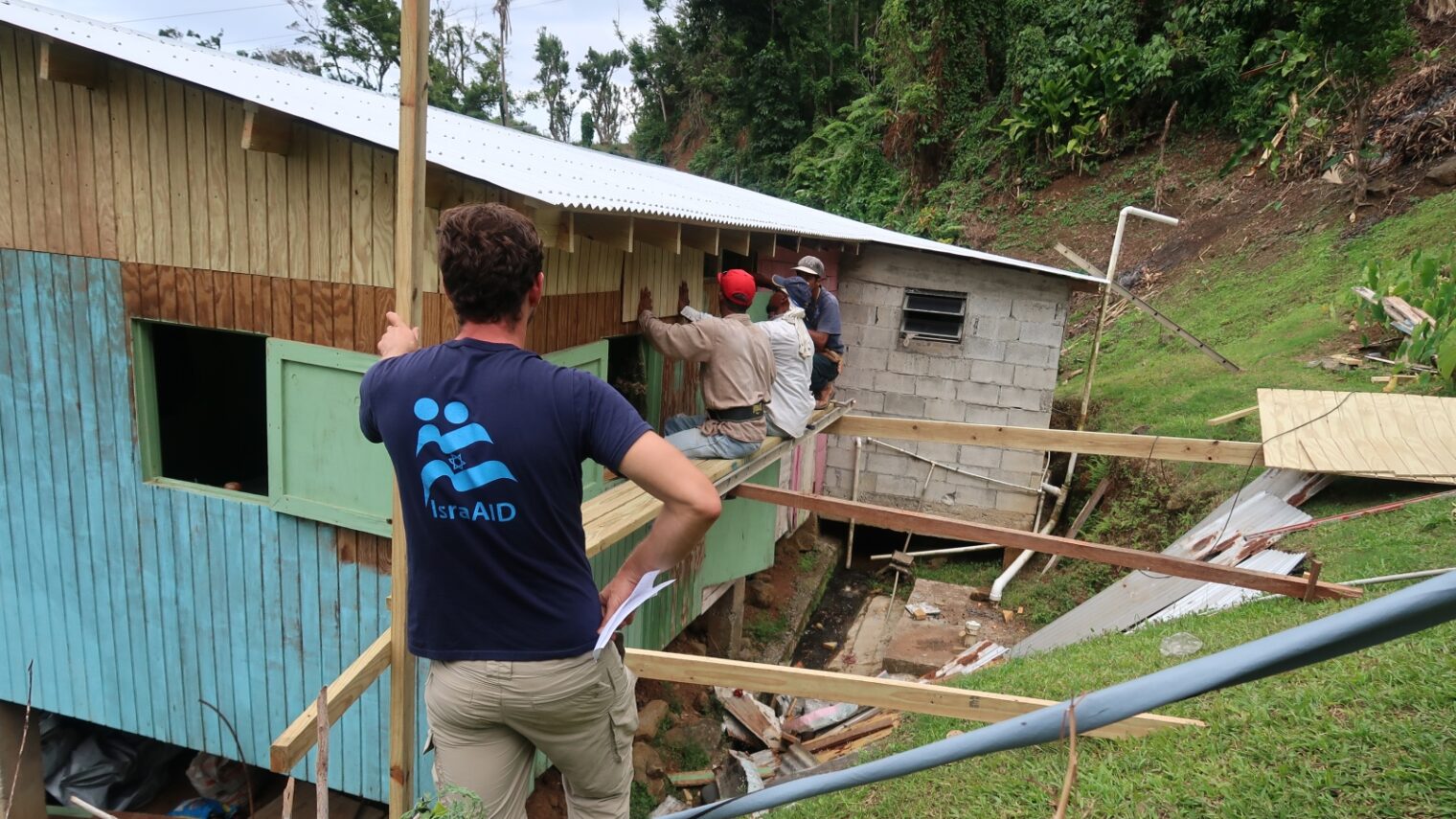 An IsraAID staffer oversees construction of a shelter in Dominica. Photo: courtesy