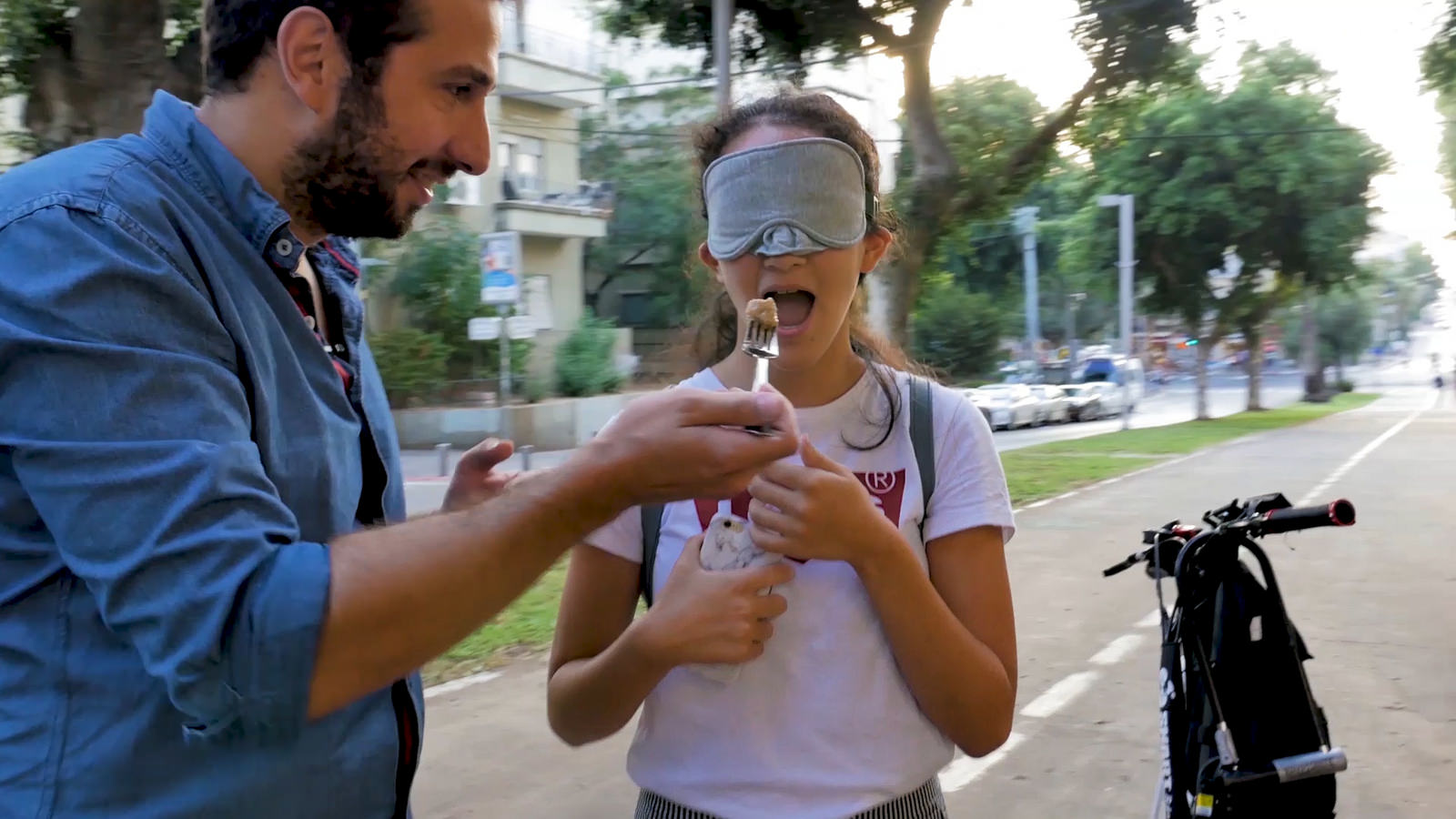 Nice or nasty? ISRAEL21c host Yuval Haklai tries out traditional Rosh Hashana foods on unsuspecting passersby. Photo still from movie
