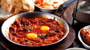 Shakshuka is served in a cast-iron pan at Dr. Shakshuka in Jaffa. Photo: courtesy