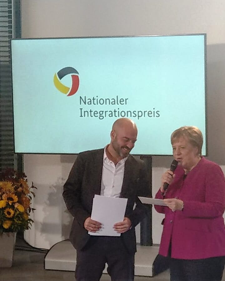 German Chancellor Angela Merkel giving the Integration Award to Gal Rachman, IsraAID country director for Germany. Photo: courtesy