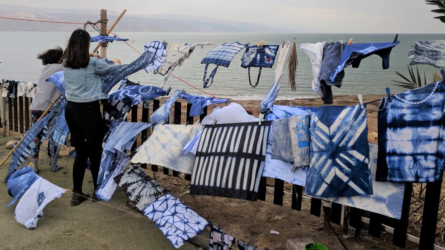 After using a traditional Japanese technique to stain textiles with organic dyes, industrial design students hang their projects to dry at Bezalel Academy’s annual Dead Sea Seminar. Photo: courtesy