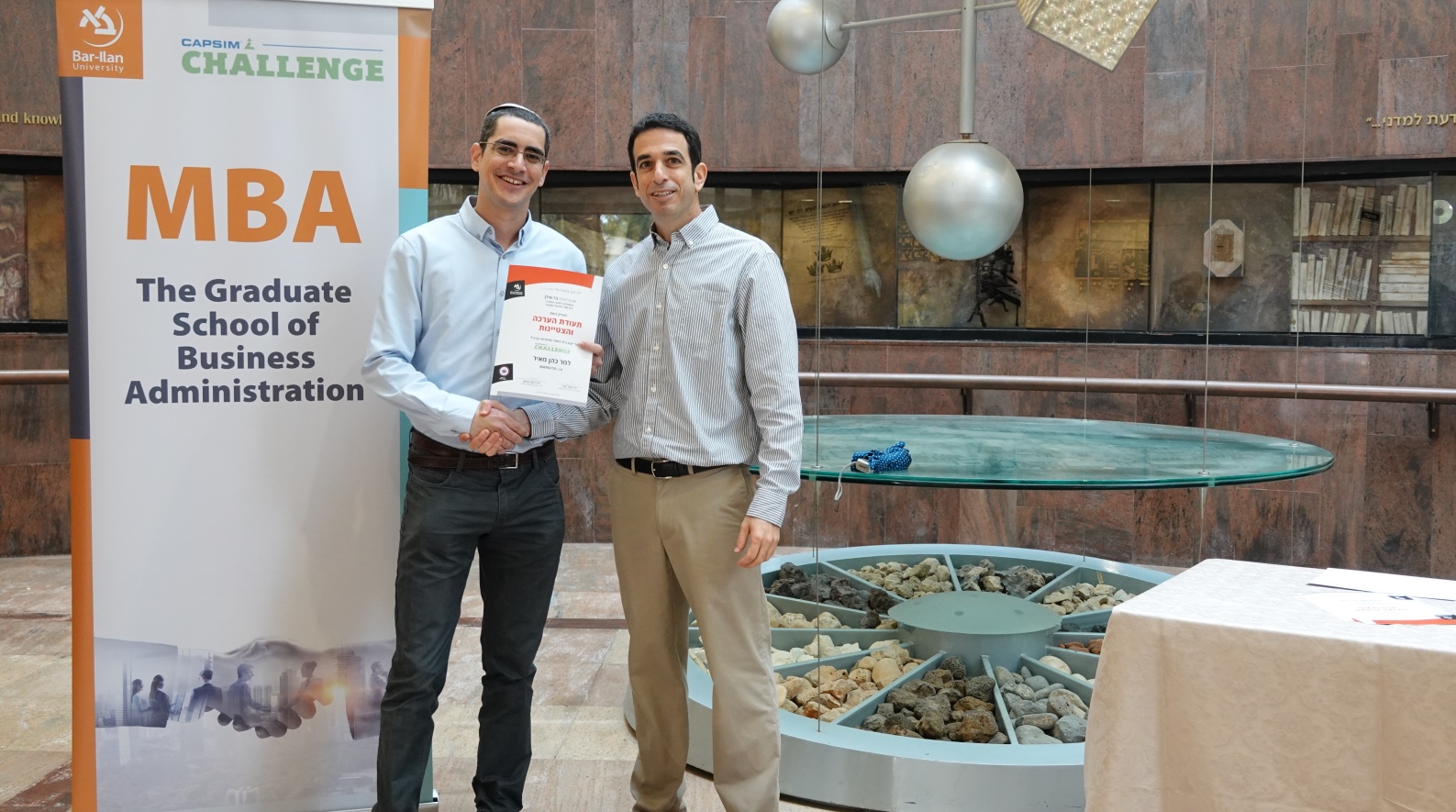 First place winner student Meir Cohen, left, and Dr. Raveh Harush from Bar-Ilan Universityâ€™s Graduate School of Business Administration at a ceremony celebrating Cohen's Capsim Challenge win. Photo: courtesy