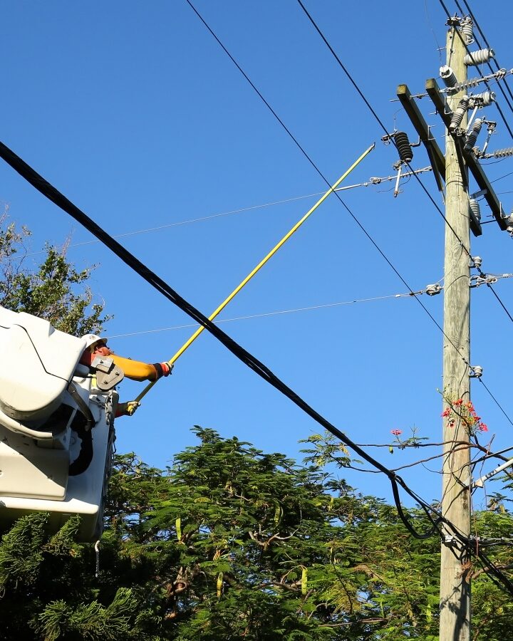 A worker connecting the power line in a Florida neighborhood six days after Hurricane Irma hit in September 2017. Photo by Jillian Cain Photography/Shutterstock.com