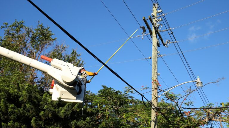 A worker connecting the power line in a Florida neighborhood six days after Hurricane Irma hit in September 2017. Photo by Jillian Cain Photography/Shutterstock.com