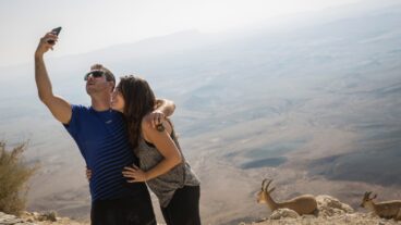An Israeli couple takes a selfie at the Ramon Crater in southern Israel. Photo by Hadas Parush/Flash90
