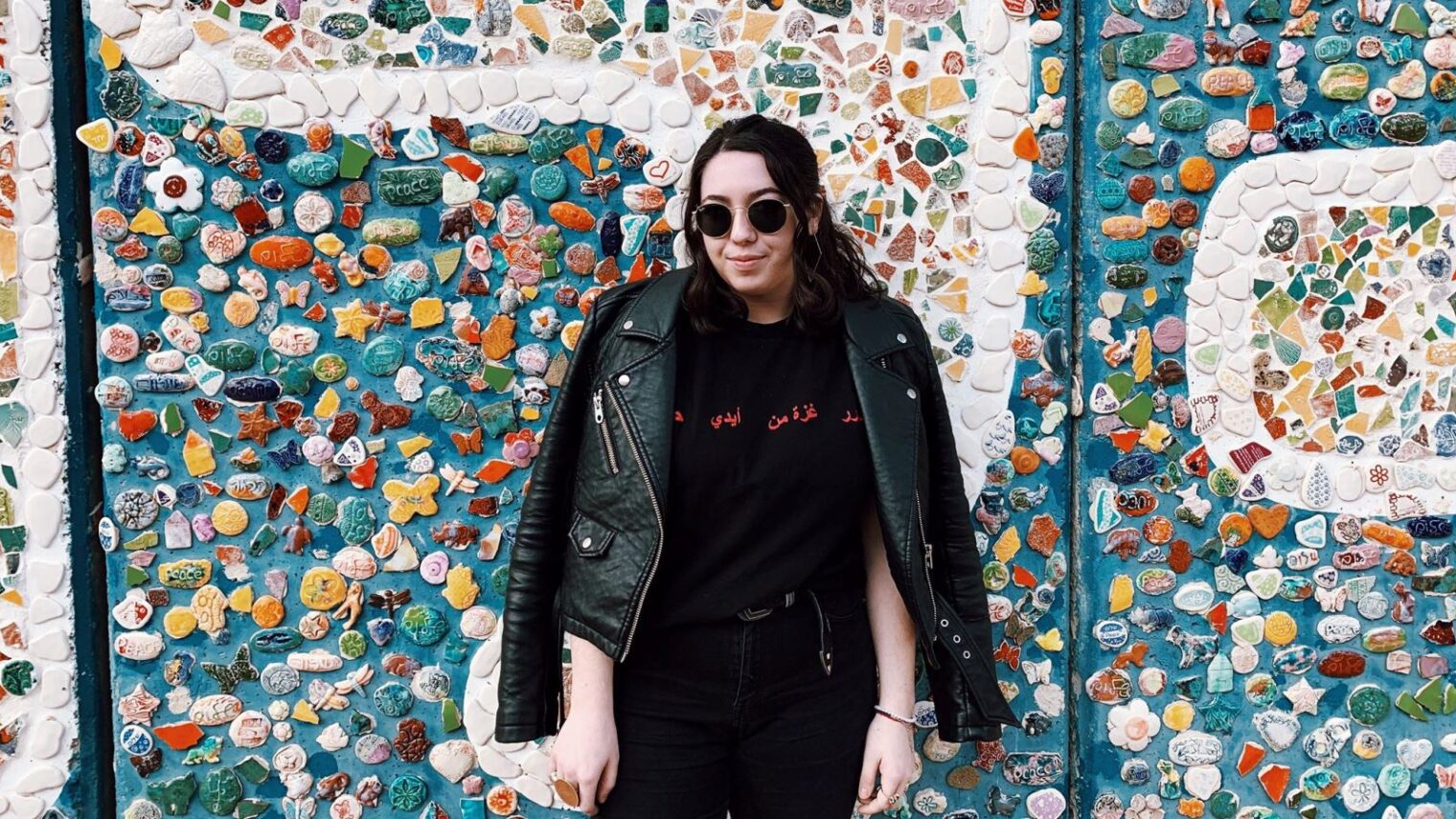 Gabrielle Weiss posing in front of a street mosaic in Israel. Photo: courtesy