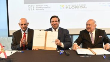 From left, Israel Innovation Authority CEO Aharon Aharon, Florida Gov. Ron DeSantis and Space Florida President and CEO Frank DiBello singing a memorandum of understanding at the Peres Center for Peace and Innovation in Tel Aviv. Photo by Jorge Novominsky