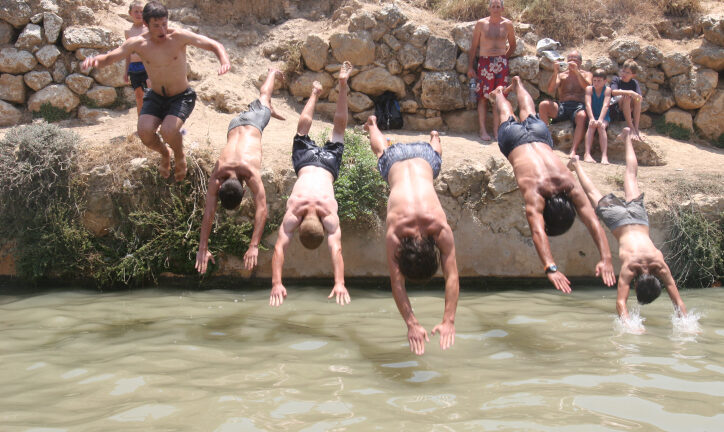 Cooling off at the Ein Lavan spring on the outskirts of Jerusalem on a hot day. Photo by Flash90