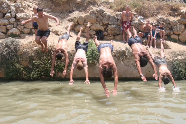 Cooling off at the Ein Lavan spring on the outskirts of Jerusalem on a hot day. Photo by Flash90