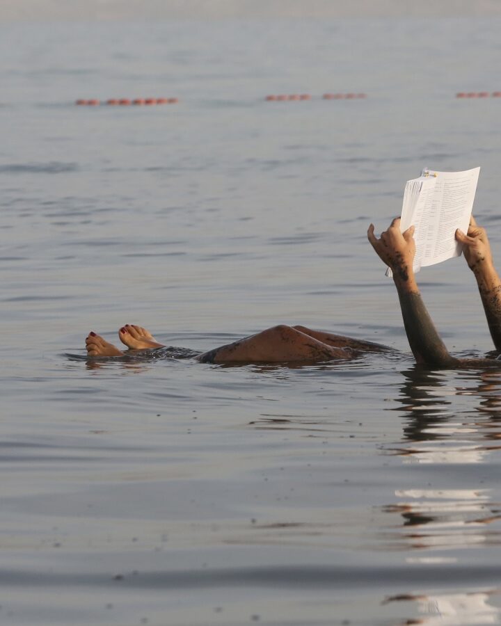 A woman floats on the water while reading a book at the Dead Sea. Photo by Yossi Zamir/Flash90