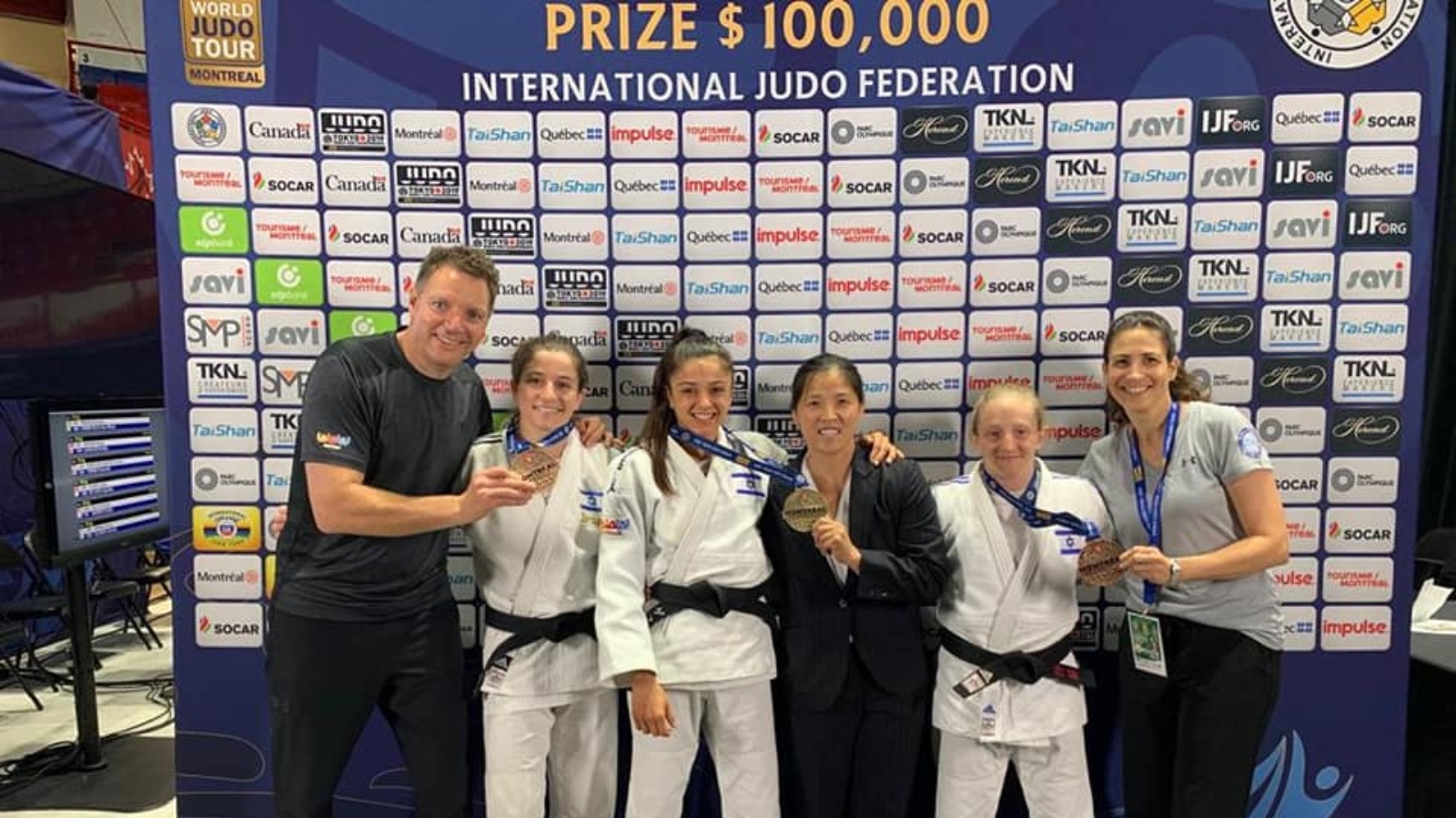 Israeli judokas Timna Nelson-Levy, Gefen Primo and Shira Rishony showing off their medals in Montreal. At left is the Israel Women’s Judo team coach, Shany Hershko. Photo courtesy of Israeli Judo Association