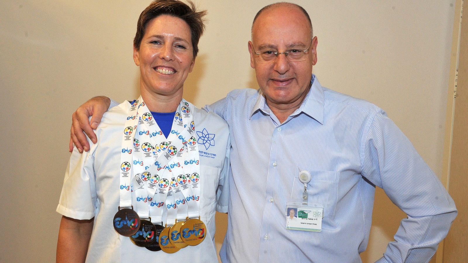 Gold-medal swimmer and ER nurse Ruthy Weiner with Galilee Medical Center CEO Dr. Masad Barhoum. Photo by Roni Albert
