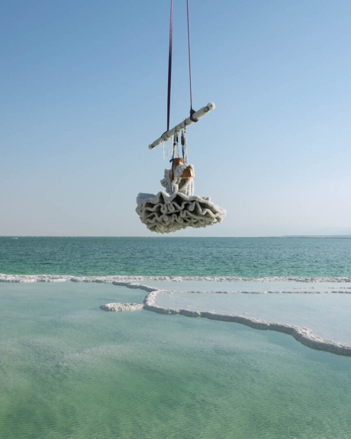 Black tutu dress coated in salt crystals and weighing 100 kg is

lifted from the Dead Sea, 2016. Photo by Shaxaf Haber, ©Sigalit Landau, 2019