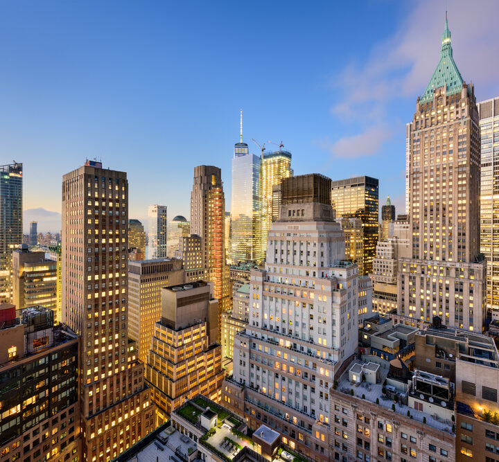 New York City’s Wall Street financial district cityscape at dusk. Image via Shutterstock.com