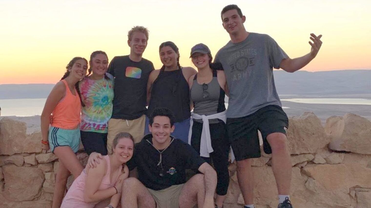 Ben Rozio (top row, third from left) and Birthright friends at the top of Masada during a sunrise hike. Photo: courtesy