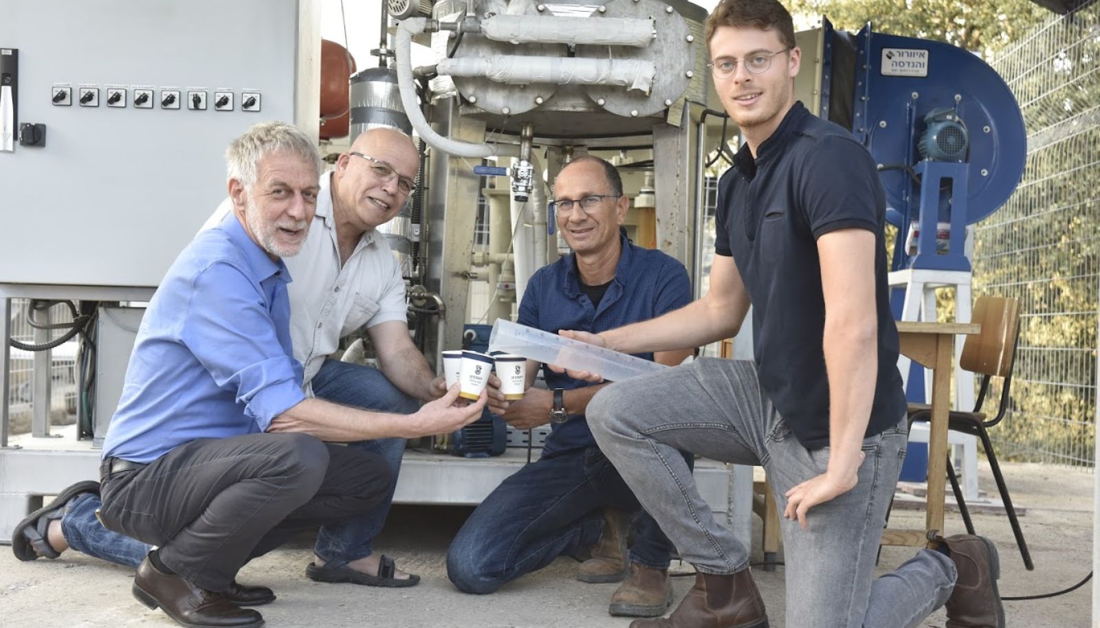 Prof. David Broday (left), Prof. Eran Frielder and their team enjoy drinking water generated from the air. Photo courtesy of the Technion