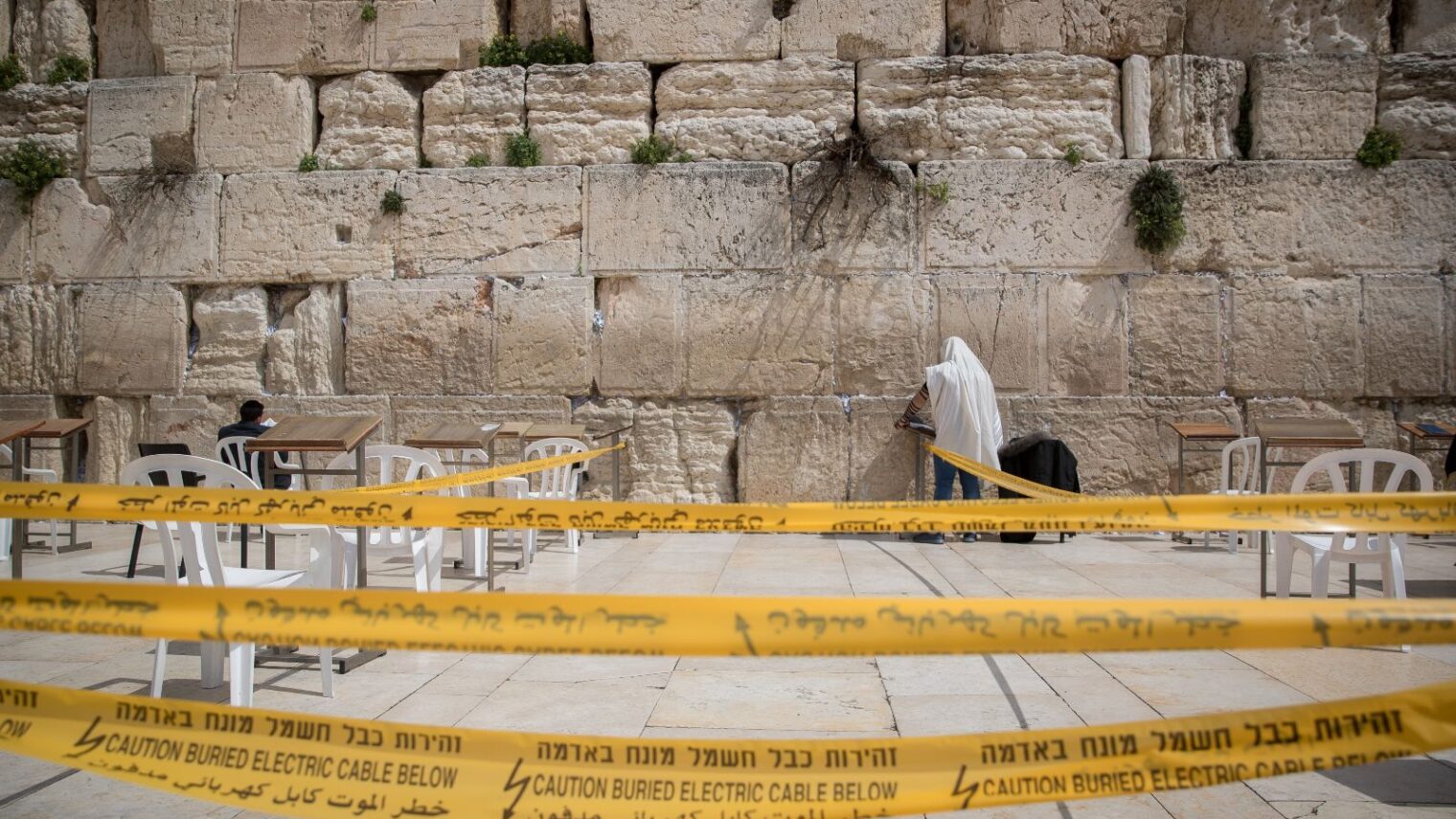 A man prays in an enclosed area at the Western Wall in Jerusalem. Photo by Yonatan Sindel/Flash90