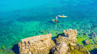 Paddleboarding off the coast of Caesarea. Photo via Shutterstock