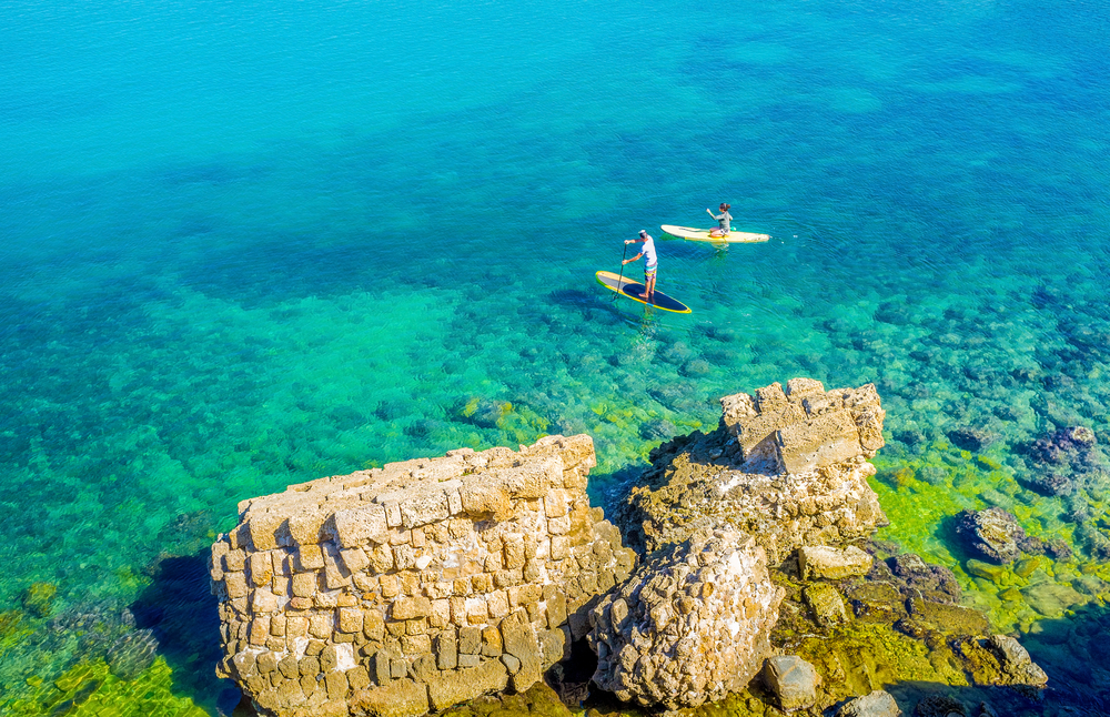 Paddleboarding off the coast of Caesarea. Photo via Shutterstock
