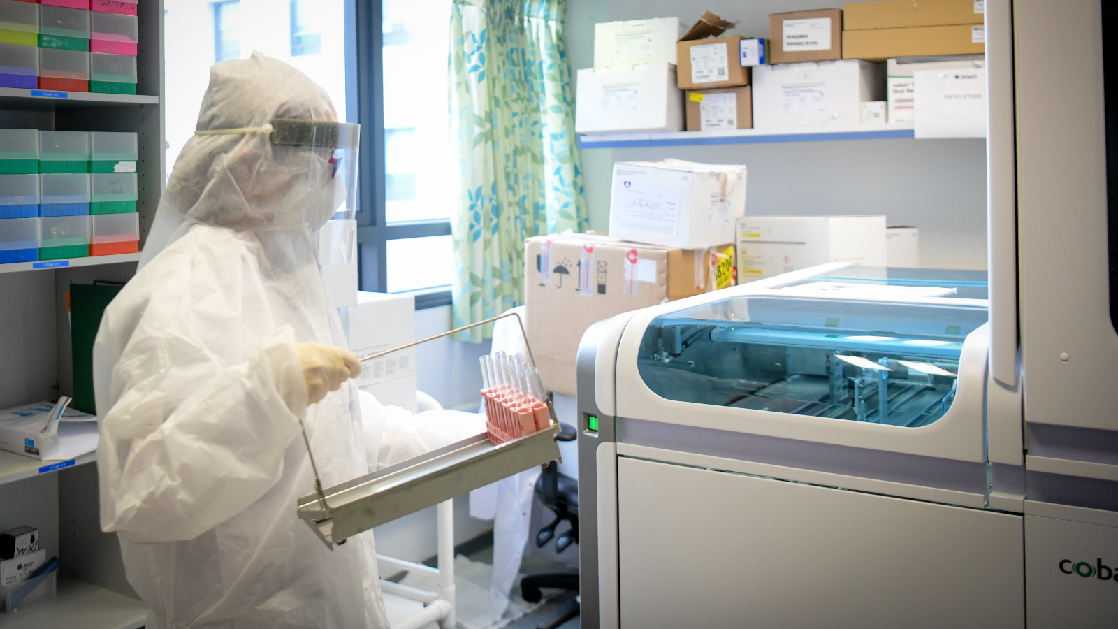 Technicians carry out a diagnostic test for coronavirus in a lab at Leumit Health Care Services branch in Or Yehuda, on March 19, 2020. Photo by Flash90