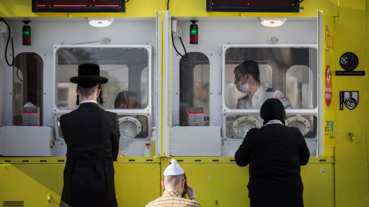 Magen David Adom testers perform Covid-19 tests in Jerusalem at a contact-free mobile testing station built by the IDF Technology and Logistics Division, April 16, 2020. Photo by Nati Shohat/Flash90