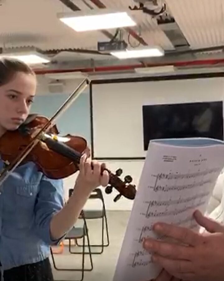 Yael can play the violin thanks to a 3D-printed prosthetic arm designed through Tikkun Olam Makers.
