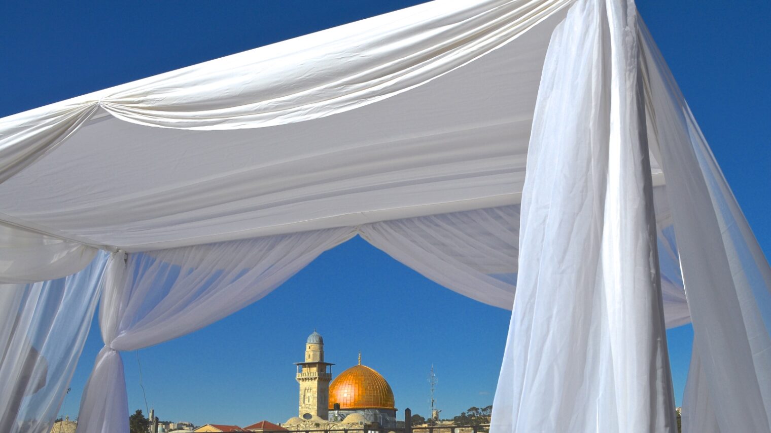 A chuppa (bridal canopy) frames the Dome of the Rock in Jerusalem. Photo by Daniel Santacruz