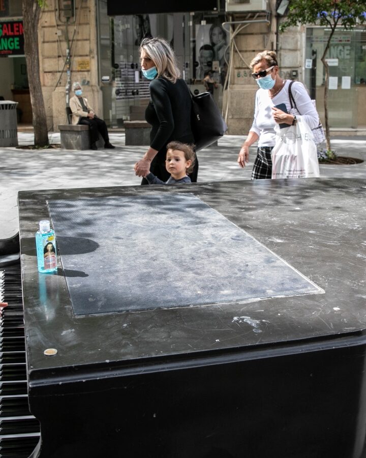 This man apparently used disinfectant gel on the keys of a public piano in downtown Jerusalem before beginning to play on May 3, 2020. Photo by Olivier Fitoussi/Flash90