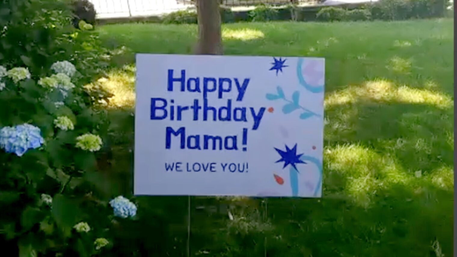 A lawn sign surprised my mother outside her virtual birthday party. Screenshot via Zoom