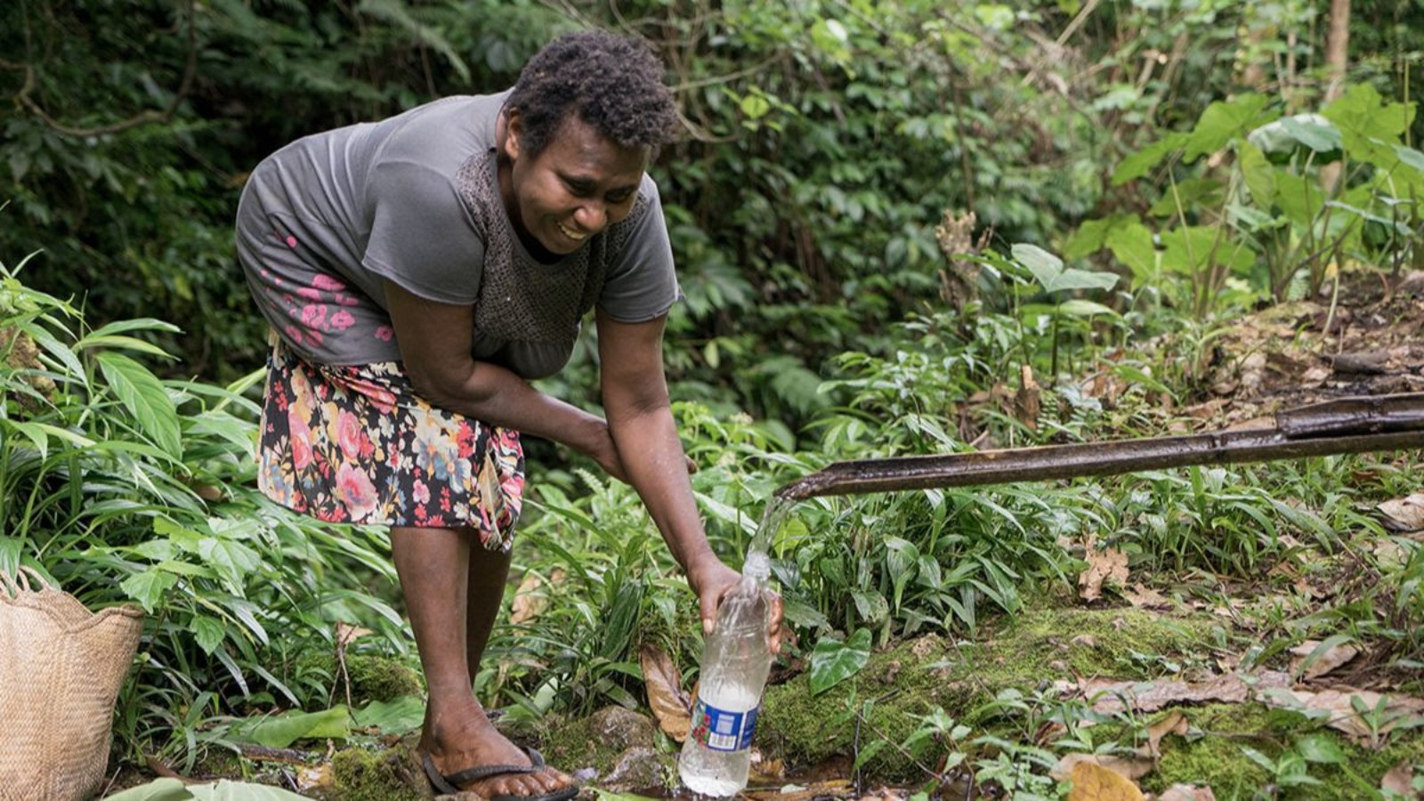 A woman collecting water in Latano, Vanuatu. Photo courtesy of IsraAID