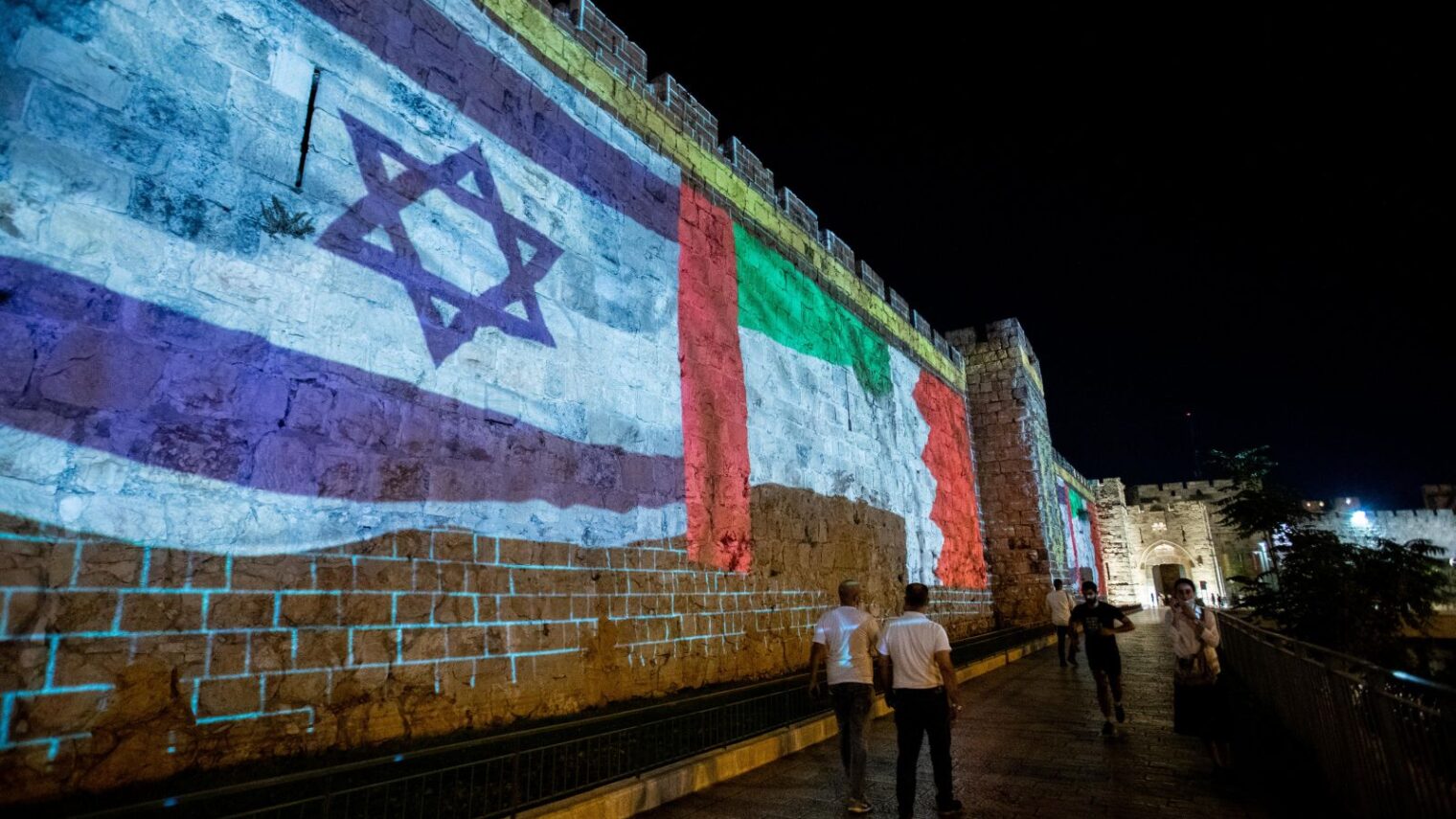 The flags of the United Arab Emirates, Israel, Bahrain and the United States are screened on the walls of Jerusalem's Old City, on September 15, 2020. Photo by Yonatan Sindel/Flash90